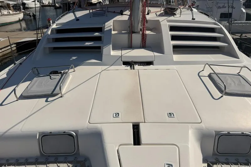 Slide: The Image of Deck of a 2000 Leopard 38 catamaran docked at a marina. - 122