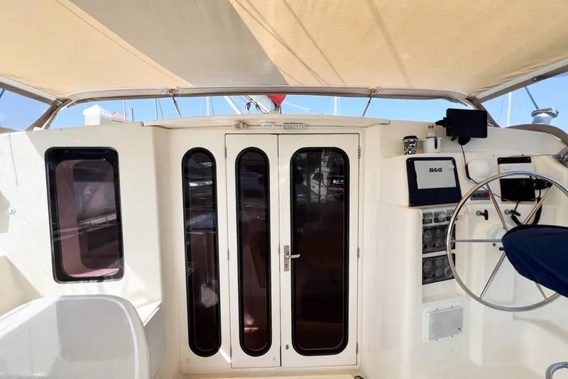 Slide: The Image of Leopard 38 catamaran cockpit with steering wheel and navigation equipment, 2000 model. - 32