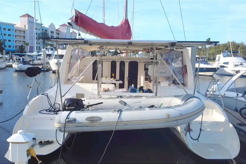 Slide: The Image of Leopard 38 catamaran from 2000 docked at marina with inflatable dinghy. - 18