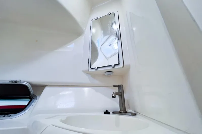 Slide: The Image of Interior of a 2000 Leopard 38 yacht bathroom with sink and mirror. - 81