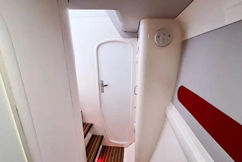 Slide: The Image of Interior of a 2000 Leopard 38 yacht, featuring a white door and wooden steps. - 56