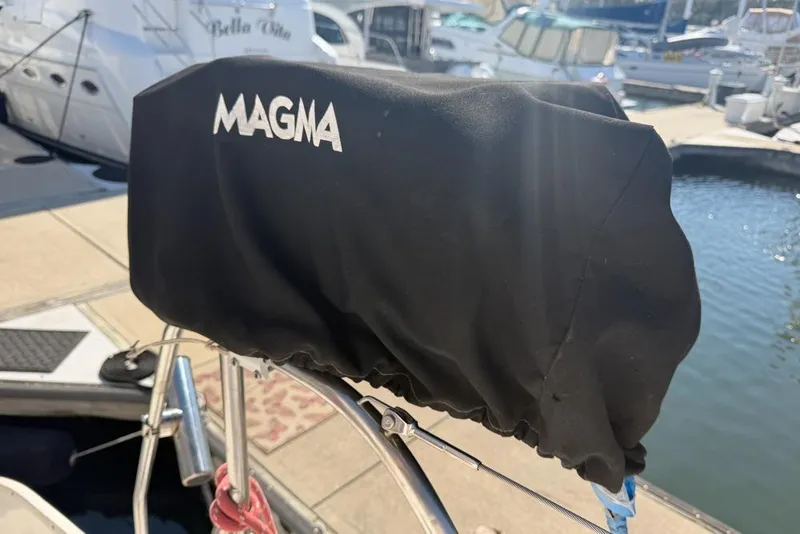 Slide: The Image of Covered Magma grill on Leopard 38 catamaran, docked at marina, sunny day. - 147