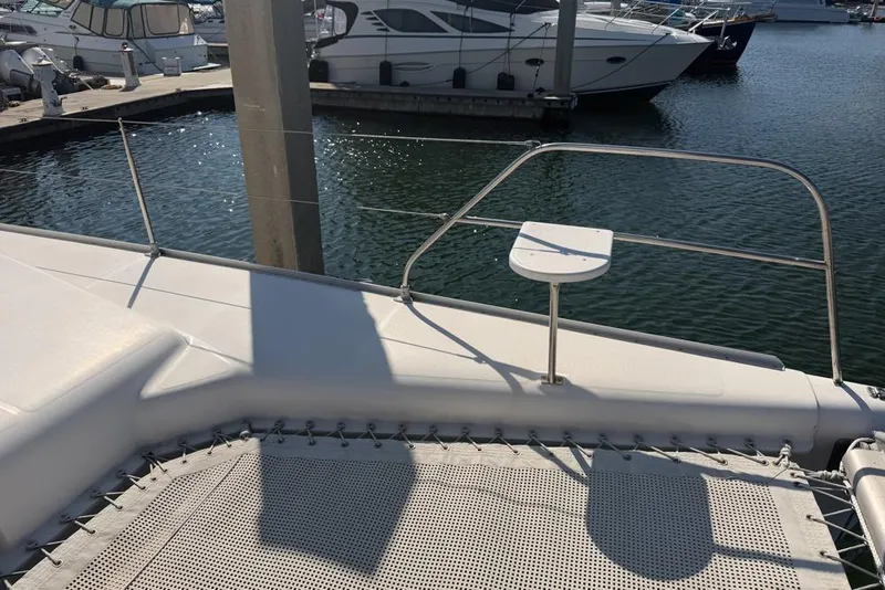 Slide: The Image of Leopard 38 catamaran deck, 2000 model, docked at marina with other boats. - 125