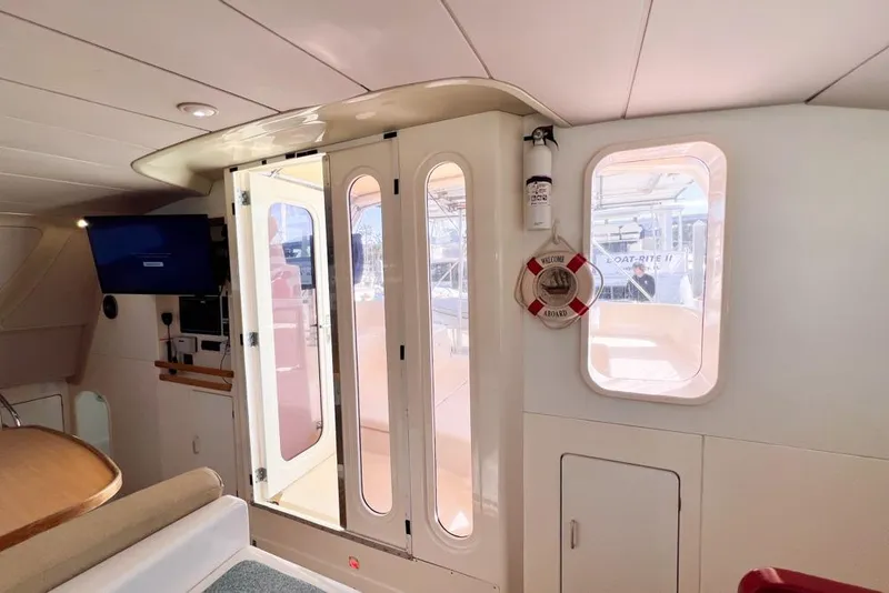 Slide: The Image of Interior of 2000 Leopard 38 yacht with glass doors and nautical decor. - 43