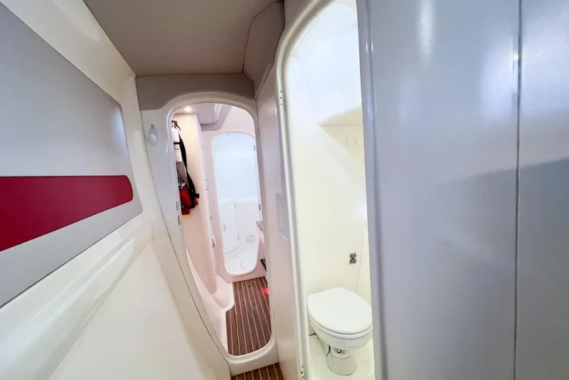 Slide: The Image of Interior of a 2000 Leopard 38 yacht featuring a compact bathroom and hallway. - 79