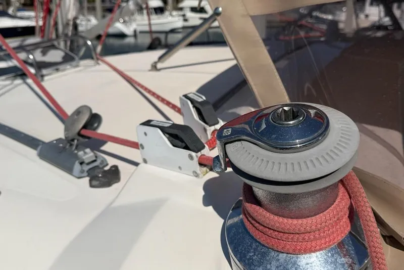 Slide: The Image of Close-up of a Leopard 38 sailboat winch and ropes, showcasing deck details. - 141
