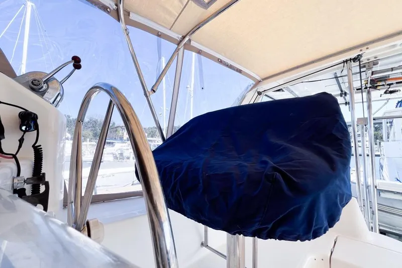 Slide: The Image of Covered helm station on a 2000 Leopard 38 catamaran, featuring stainless steel wheel. - 24