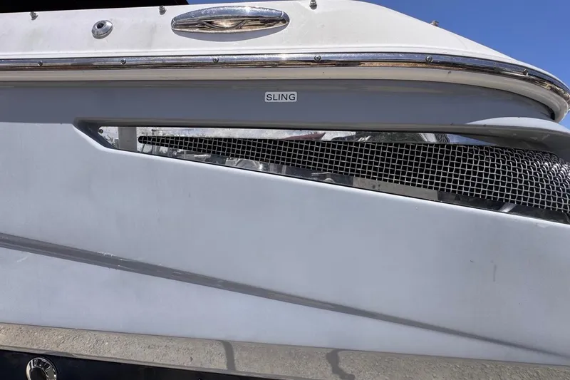 Slide: The Image of 2015 Four Winns H290 boat side view with "SLING" label and chrome details. - 9
