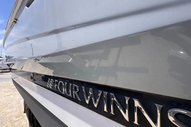 Slide: The Image of 2015 Four Winns H290 boat side view with logo in sunlight. - 10
