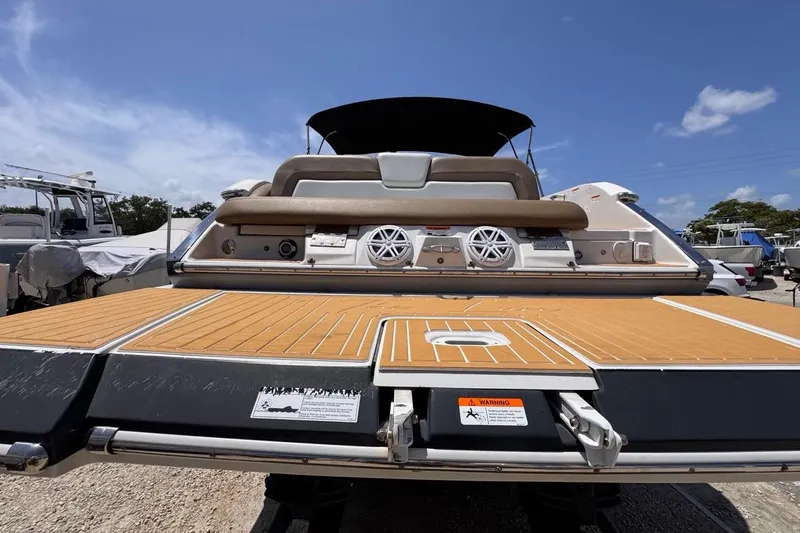 Slide: The Image of 2015 Four Winns H290 boat with spacious deck and modern audio system. - 18