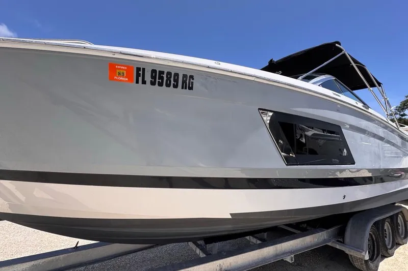 Slide: The Image of 2015 Four Winns H290 boat on trailer, Florida registration visible. - 4