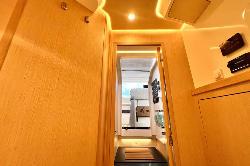 Slide: The Image of Interior view of 2024 Skamander 100 Sorrento boat, featuring modern wood paneling and ambient lighting. - 198