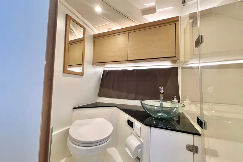 Slide: The Image of Modern bathroom in 2024 Skamander 100 Sorrento yacht with glass sink and wooden cabinets. - 200