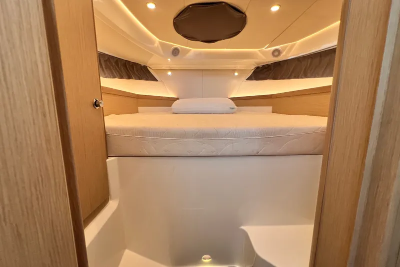 Slide: The Image of 2024 Skamander 100 Sorrento cabin interior with cozy bed and ambient lighting. - 192
