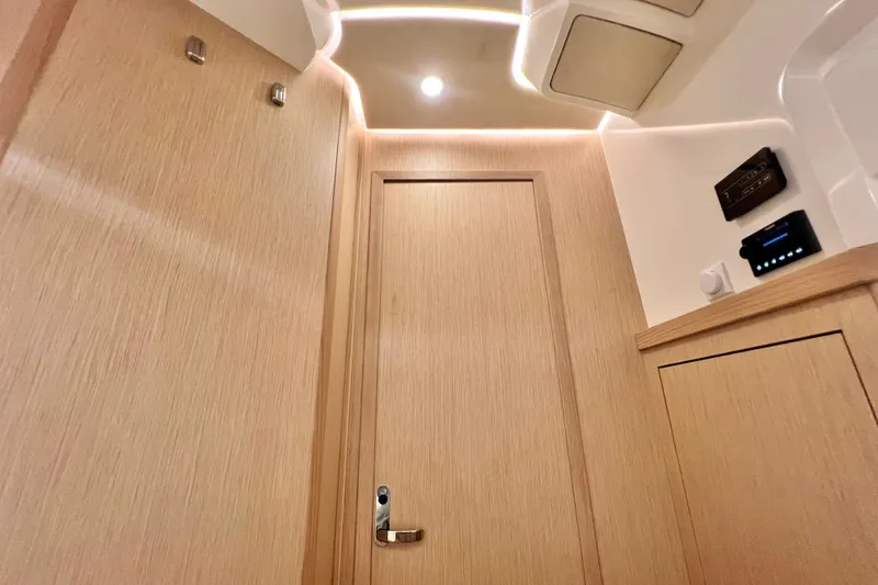 Slide: The Image of Interior of 2024 Skamander 100 Sorrento, featuring modern wood paneling and ambient lighting. - 199