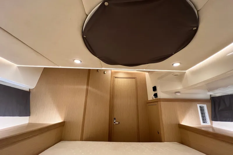 Slide: The Image of 2024 Skamander 100 Sorrento cabin interior with modern wood finish and ambient lighting. - 195