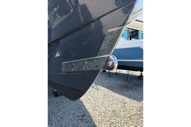 Slide: The Image of 2019 Regulator 41 boat hull detail with chrome fittings, displayed on gravel. - 4