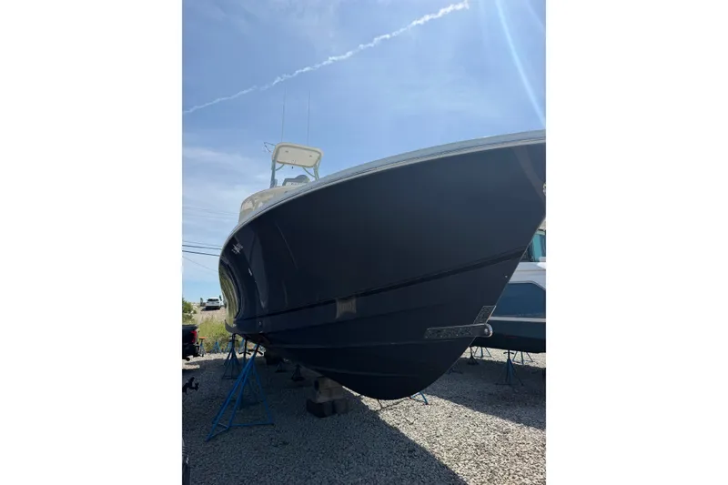 Slide: The Image of 2019 Regulator 41 boat on stands under clear blue sky. - 2