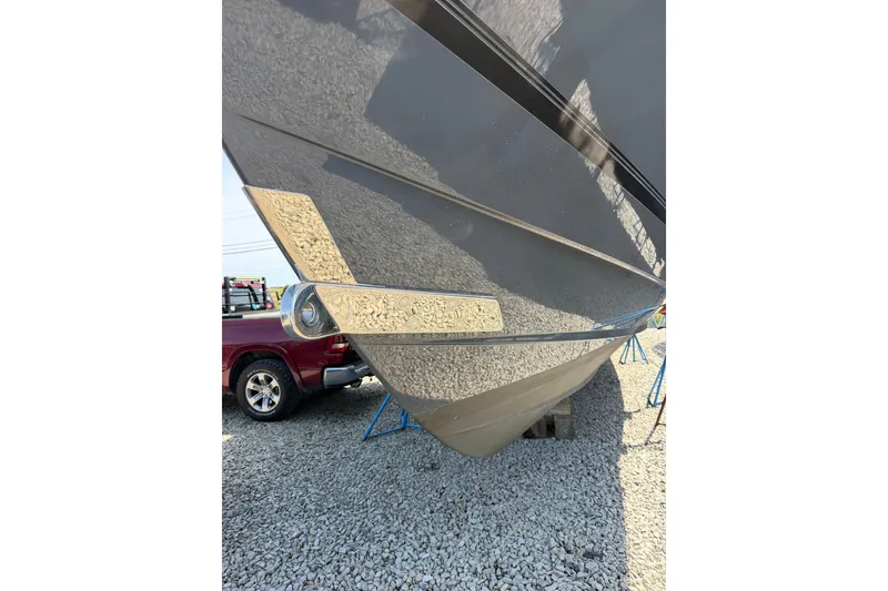 Slide: The Image of 2019 Regulator 41 boat hull on gravel, with a red truck in the background. - 3