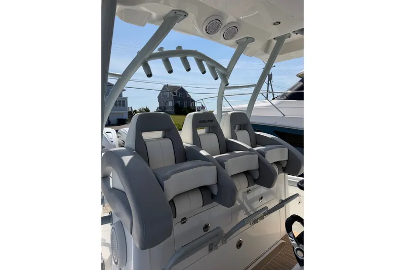 Slide: The Image of 2019 Regulator 41 boat interior with cushioned seating and overhead rod holders. - 28