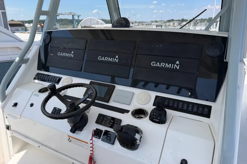 Slide: The Image of Cockpit of 2019 Regulator 41 boat with Garmin navigation displays and steering wheel. - 30