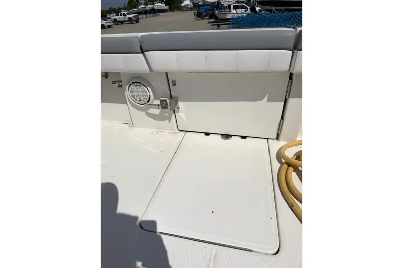 Slide: The Image of 2019 Regulator 41 boat deck with seating and speaker, docked outdoors. - 27