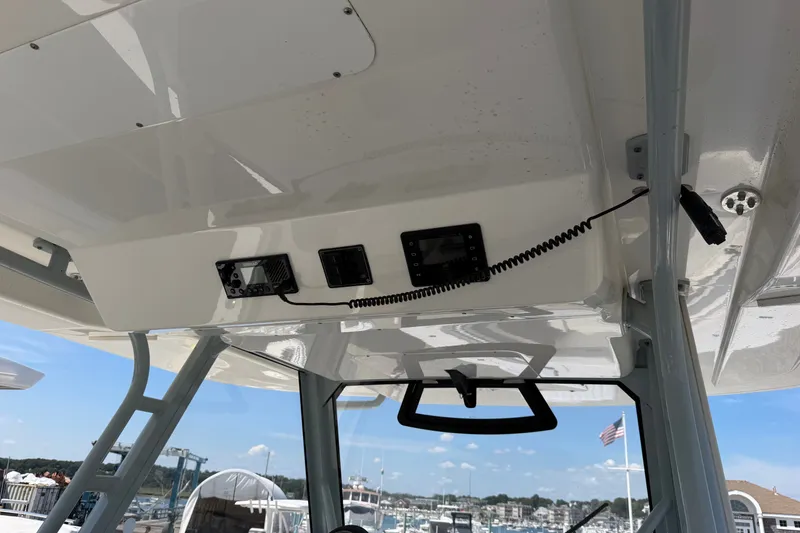 Slide: The Image of 2019 Regulator 41 boat console with electronic controls and American flag in background. - 35