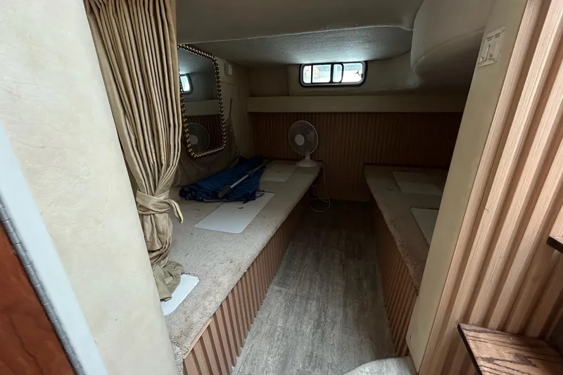 Slide: The Image of Interior cabin of 2000 Monterey 330 Sport Yacht with twin beds and a small fan. - 55