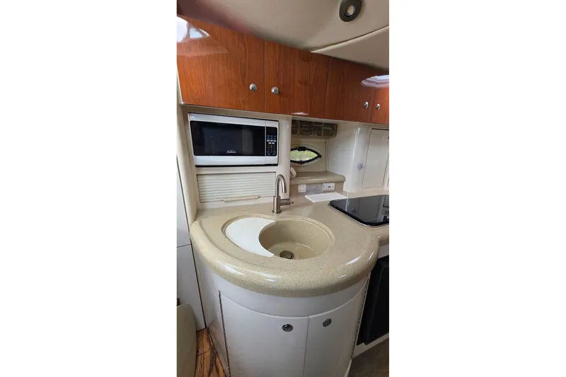 Slide: The Image of Compact kitchen area in a 2000 Monterey 330 Sport Yacht with sink and microwave. - 60