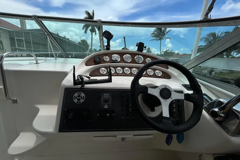 Slide: The Image of Cockpit view of a 2000 Monterey 330 Sport Yacht with steering wheel and gauges. - 21