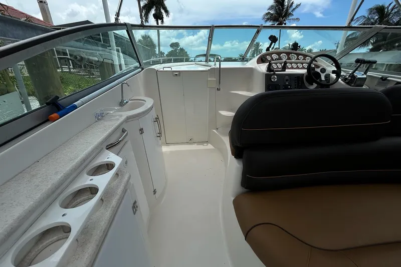 Slide: The Image of Interior of 2000 Monterey 330 Sport Yacht with helm, seating, and sink. - 15
