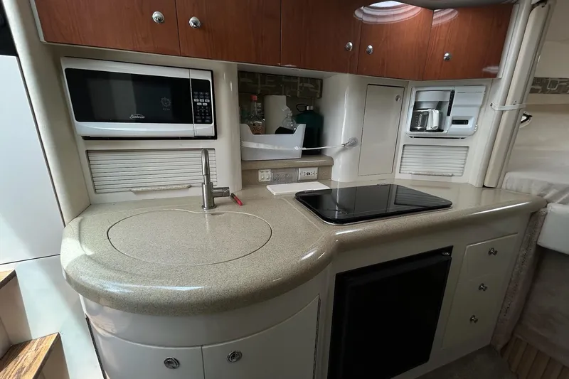 Slide: The Image of Compact kitchen in a 2000 Monterey 330 Sport Yacht with microwave, stove, and sink. - 39