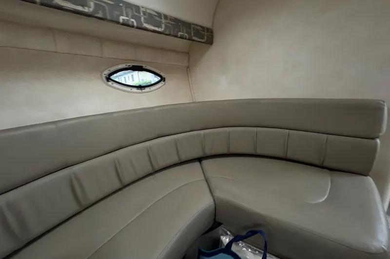 Slide: The Image of Interior of 2000 Monterey 330 Sport Yacht with curved seating and porthole window. - 50