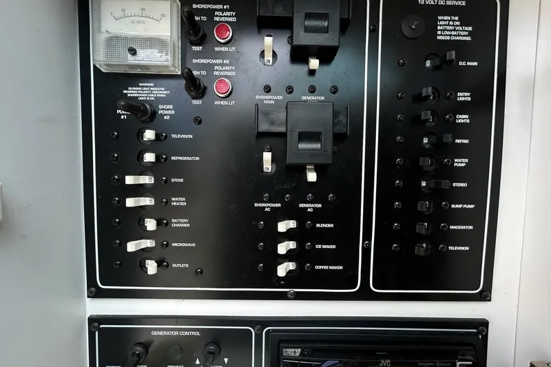 Slide: The Image of Electrical control panel on a 2000 Monterey 330 Sport Yacht, featuring switches and gauges. - 43