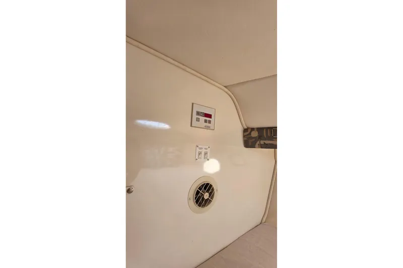 Slide: The Image of Interior view of a 2000 Monterey 330 Sport Yacht cabin with control panel and vent. - 65