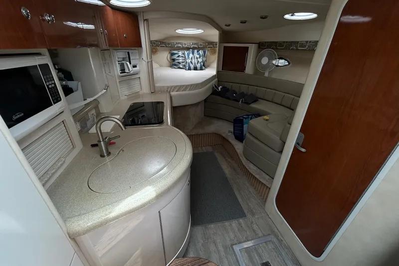 Slide: The Image of Interior of a 2000 Monterey 330 Sport Yacht with kitchenette and seating area. - 38