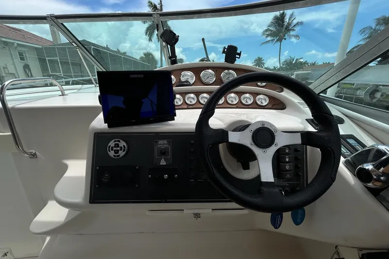 Slide: The Image of Cockpit of 2000 Monterey 330 Sport Yacht with steering wheel and navigation equipment. - 34