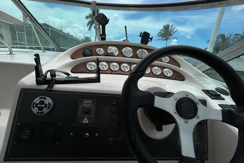 Slide: The Image of Cockpit view of a 2000 Monterey 330 Sport Yacht with steering wheel and instrument panel. - 22