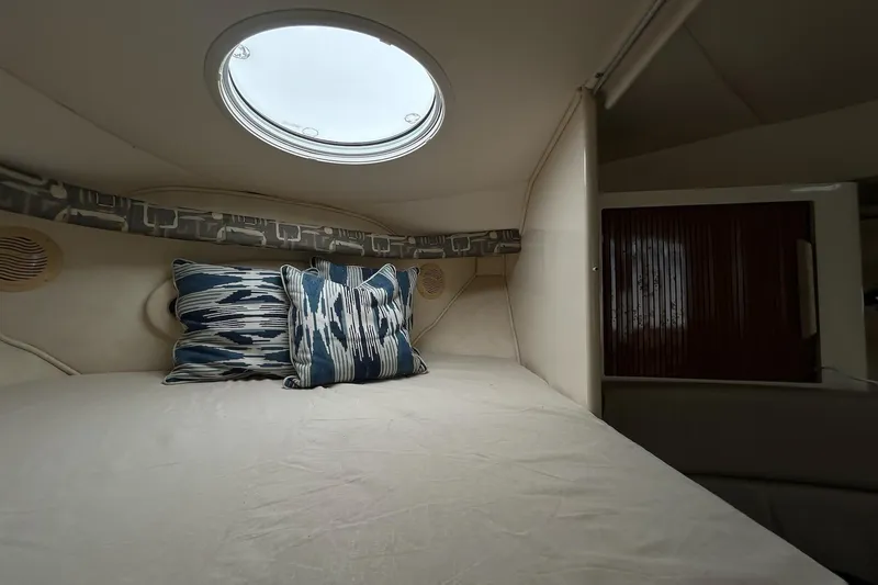 Slide: The Image of Interior cabin of 2000 Monterey 330 Sport Yacht with decorative pillows and porthole. - 48