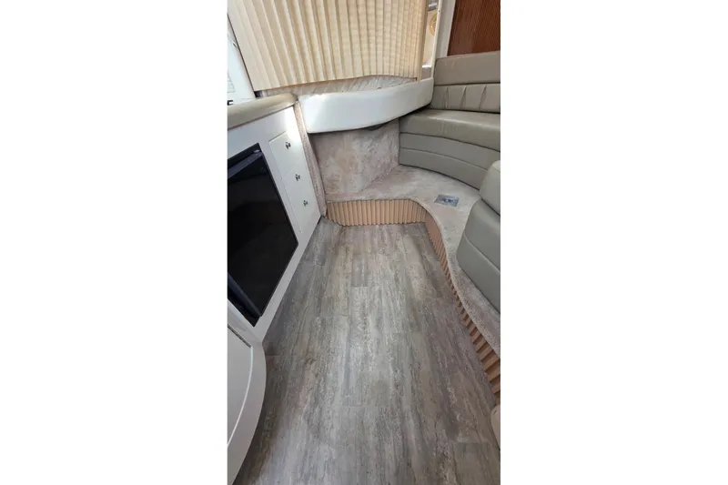 Slide: The Image of Interior of 2000 Monterey 330 Sport Yacht with wood flooring and beige seating. - 63