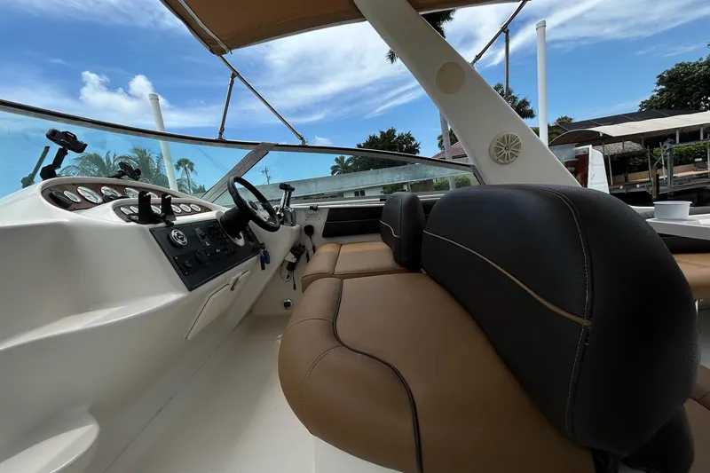 Slide: The Image of Interior view of a 2000 Monterey 330 Sport Yacht cockpit with steering wheel and controls. - 17
