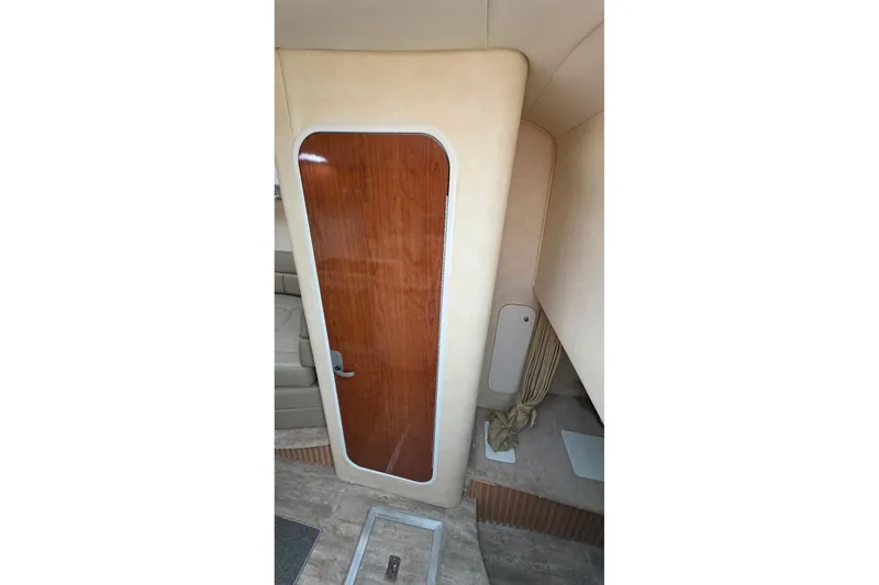 Slide: The Image of Interior cabin door of 2000 Monterey 330 Sport Yacht, featuring wood finish and beige walls. - 67