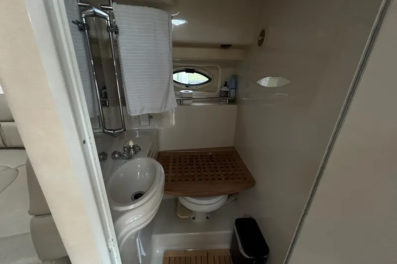 Slide: The Image of Bathroom interior of 2000 Monterey 330 Sport Yacht with sink and wooden accents. - 54