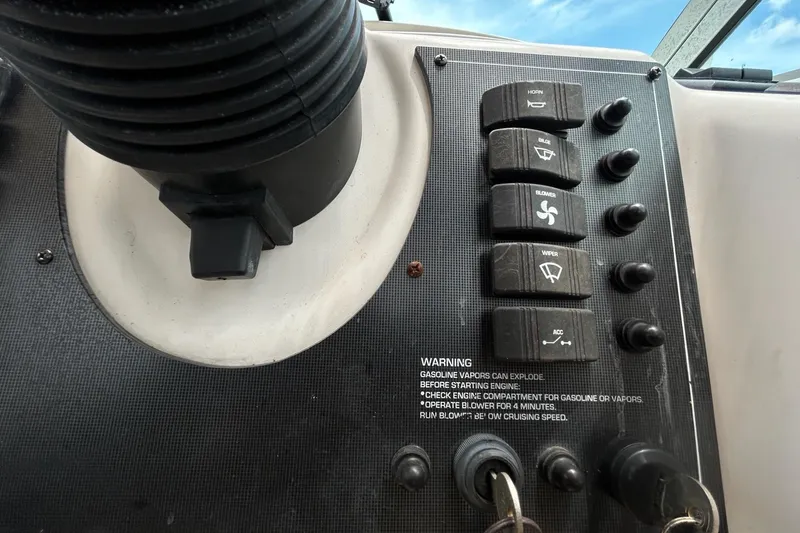 Slide: The Image of Control panel of a 2000 Monterey 330 Sport Yacht with labeled switches and warning text. - 27