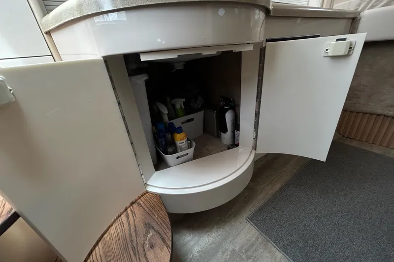 Slide: The Image of Open cabinet in 2000 Monterey 330 Sport Yacht with cleaning supplies and fire extinguisher. - 41