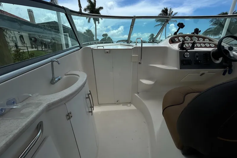 Slide: The Image of Cockpit view of 2000 Monterey 330 Sport Yacht with steering wheel and control panel. - 16