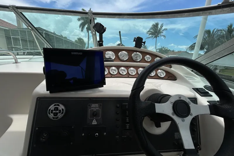 Slide: The Image of Cockpit view of 2000 Monterey 330 Sport Yacht with steering wheel and navigation system. - 36