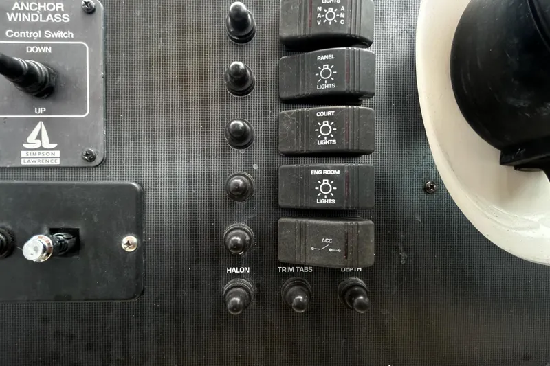 Slide: The Image of Control panel of a 2000 Monterey 330 Sport Yacht with various switches and buttons. - 25