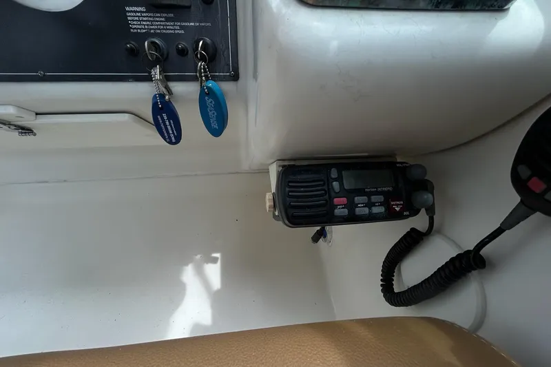 Slide: The Image of Control panel of a 2000 Monterey 330 Sport Yacht with keys and radio equipment. - 29