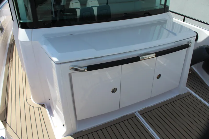 Slide: The Image of 2022 Axopar 37 XC Cross Cabin Brabus deck with storage compartments. - 24